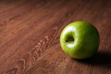 fresh green apple on a wooden table