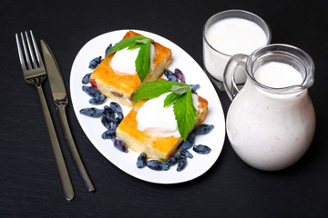 Appetizing cottage cheese casserole with berries and sour cream