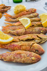 Plate of fried small fish red mullet