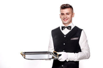 Portrait of young happy smiling waiter with on tray isolated on
