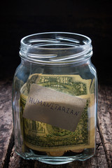 jar for collection of funds in need on a wooden background