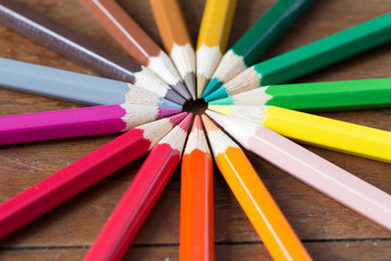 Naklejka premium color pencils on wooden table