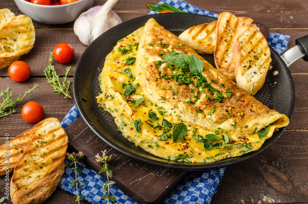 Wall mural herb omelette with chives and oregano sprinkled with herb omelette with chili flakes