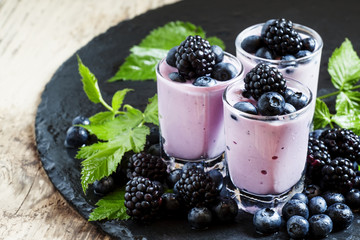 Fototapeta na wymiar Homemade yogurt and milk cocktail with blackberries and blueber