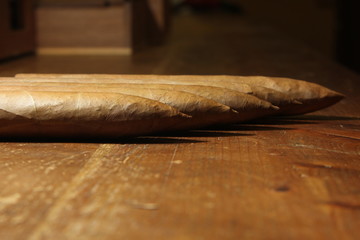 four raw pyramid cuban cigars over a table