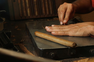 Cuban cigars roller cutting on his bench