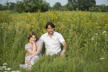 Loving couple relaxing on a meadow