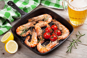 Grilled shrimps on frying pan and beer