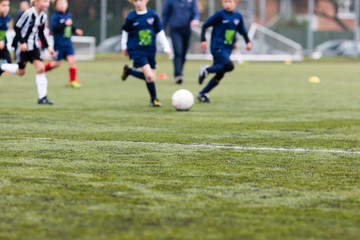Fototapeta premium Blurred kids playing soccer