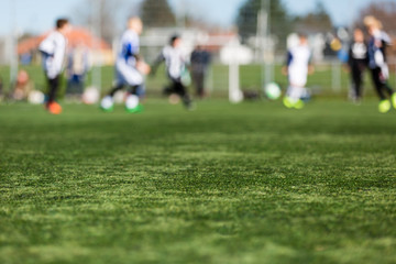 Obraz na płótnie Canvas Blurred Kids Playing Soccer