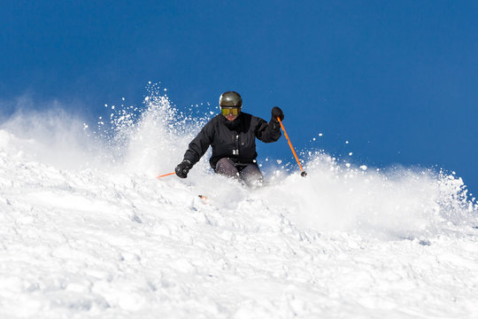 Skier skiing off piste in powder snow