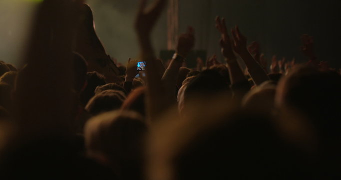 Man Taking Photos of the Concert on Smartphone