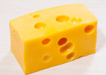 piece of fresh delicious cheese with holes
