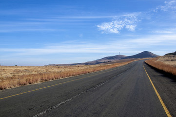 Worn Asphalt Road Heading into the Mountains