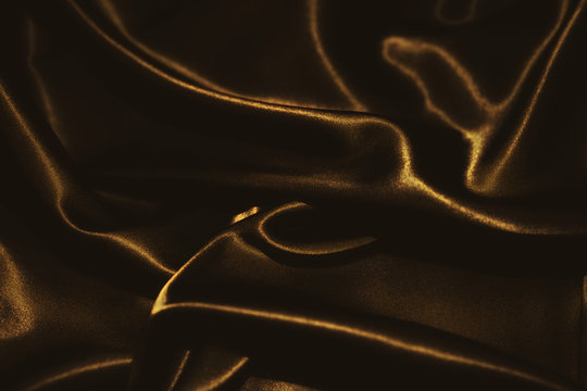 delicate waves of golden satin silk