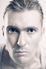 Young man with a metallic makeup on her face