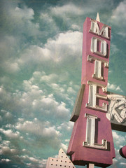aged and worn vintage photo of motel sign
