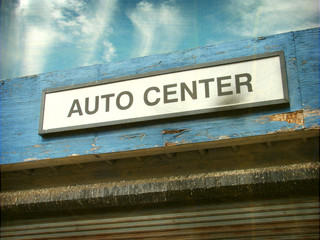 aged and worn vintage photo of auto center sign