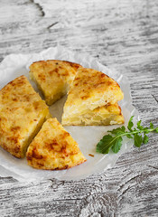 potato tortilla on a light wooden background