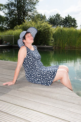 attractive woman siiting with legs in  the pool