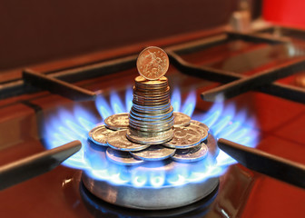 Gas burner with a blue flame and coins