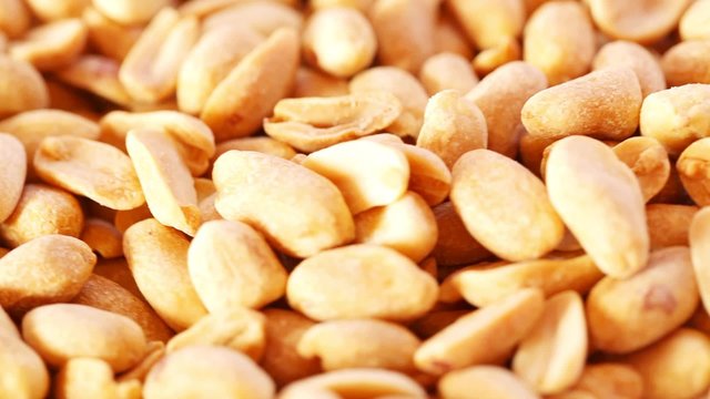 Roasted salty peanuts seed at rotating stand; close up; no people; HD 1080 