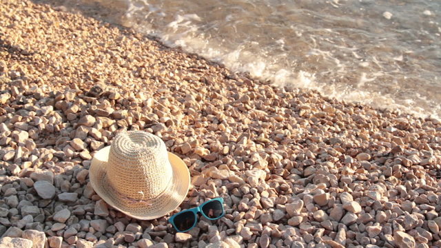 hat and sunglasses on beach