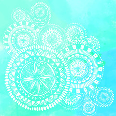 Blue watercolor brush strokes with white hand drawn mandalas -