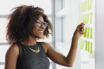 Portrait of a smiling business woman with an afro in bright