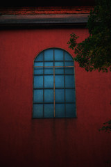 window in the wall of the old red house