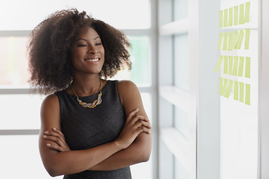 Portrait of a smiling business woman with an afro in bright