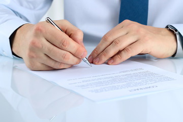 Businessman is signing a contract, business contract details