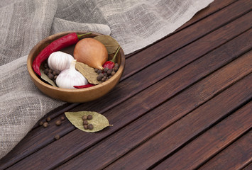 dish with spices on a wooden background. top view