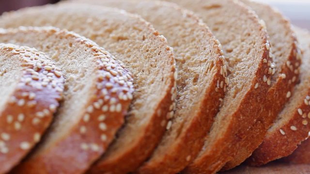 Bread With Sesame Seed Finely Sliced At Rotating Stand; Close Up