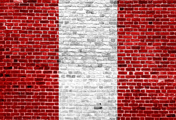 Flag of Peru painted on brick wall, background texture