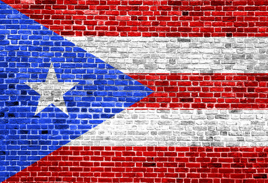 Flag of Puerto Rico painted on brick wall, background texture