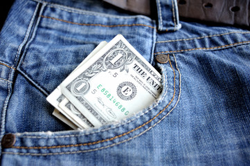 One dollar bill in a pocket of blue jeans.