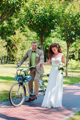 Bride and groom on tandem bike
