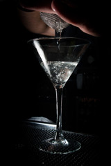 preparing margarita coctail in long wineglass