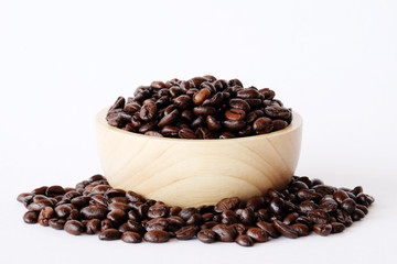 Coffee beans in wooden bowl isolated on white background