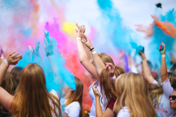 People throwing up colorful powder paint; having fun at holi festival - Powered by Adobe