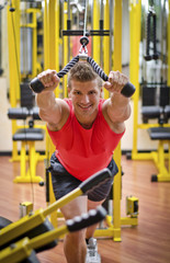 Young man training on gym equipment