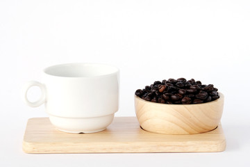 Coffee beans in wood bowl and coffee cup on wood tray