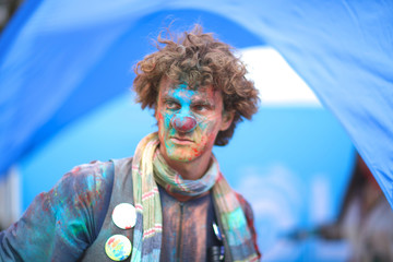 Curly clown in colors at holi festival