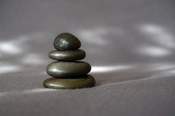 Fototapeta na wymiar This is a stack of stones against a serene soft gray background.