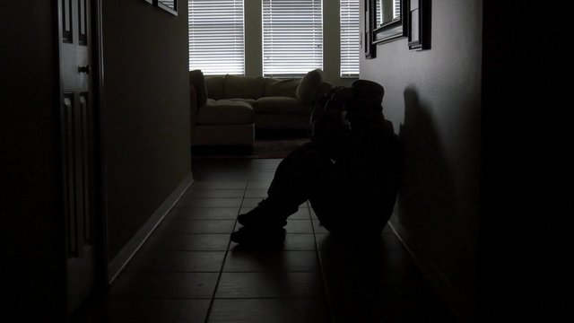 A soldier with PTSD starts crying in lonely hallway, WIDE, 4K
