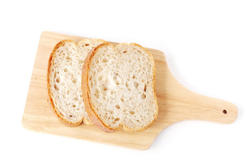 Whole wheat bread on wooden tray isolated on white background