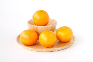 Oranges on wooden tray isolated on white backgound