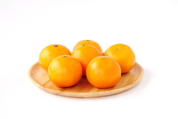 Oranges on wooden tray isolated on white backgound
