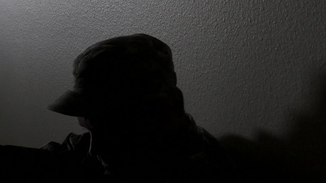 Closeup of a soldier's head while sitting in the hallway battling depression, 4K
